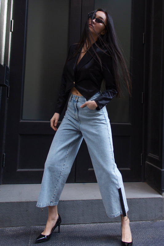 a woman wearing jeans and a black shirt